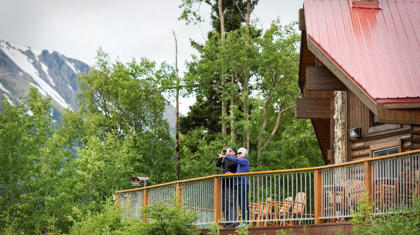 A couple on the deck of Kenai Princess Wilderness Lodge