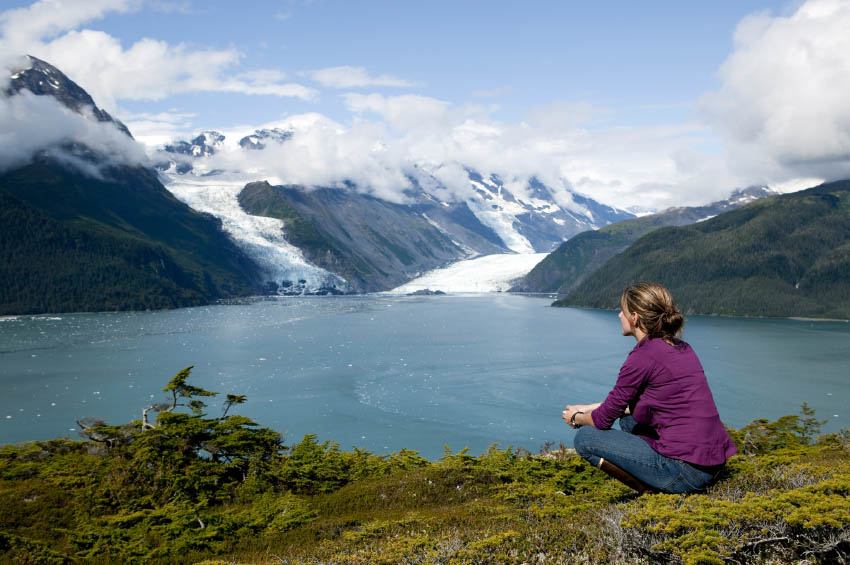 woman sitting near alaska glacier